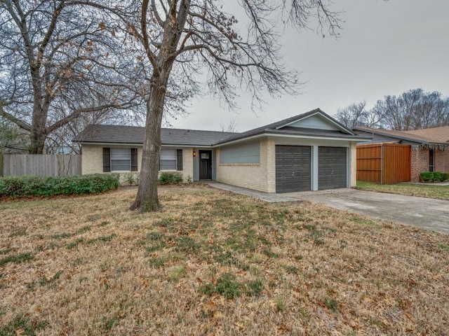 ranch-style house featuring a garage, fence, a front lawn, and concrete driveway