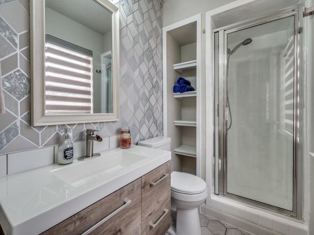 full bath featuring toilet, a stall shower, backsplash, and vanity