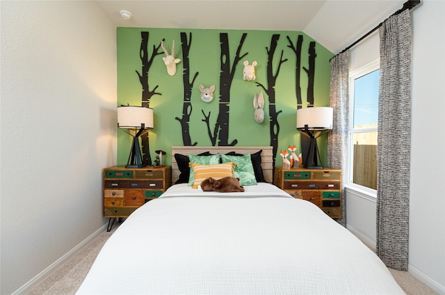 bedroom with lofted ceiling, carpet flooring, and baseboards