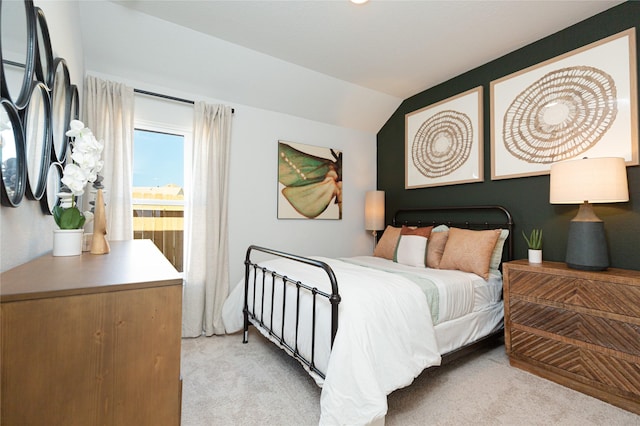 bedroom featuring light carpet and vaulted ceiling