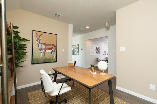 office area featuring baseboards, a textured ceiling, visible vents, and dark wood-type flooring