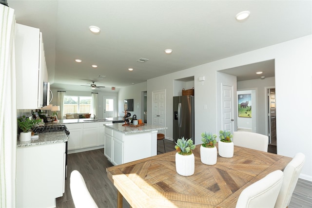 dining area featuring dark wood-style floors, recessed lighting, and visible vents