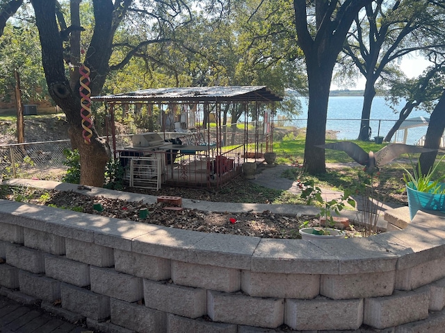 view of yard with a water view and fence