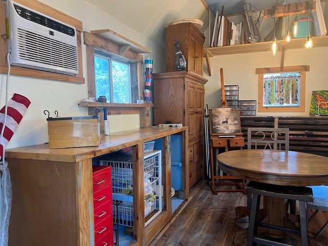 interior space featuring an AC wall unit and wood finished floors