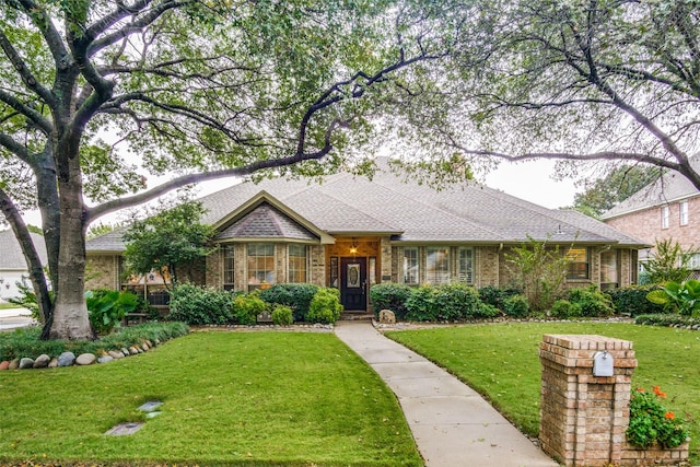 ranch-style home with brick siding and a front lawn