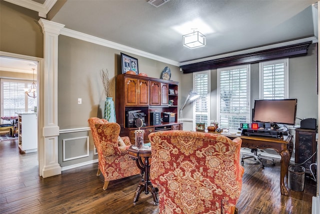 dining space featuring crown molding, dark wood finished floors, decorative columns, a decorative wall, and wainscoting