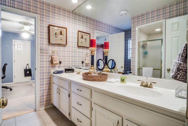 full bath with tile patterned floors, a sink, and wallpapered walls