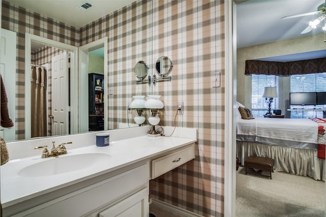 ensuite bathroom featuring visible vents, ensuite bathroom, ceiling fan, vanity, and wallpapered walls