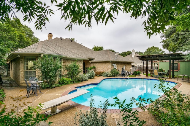 view of swimming pool with a fenced in pool, fence, a patio area, a diving board, and a pergola