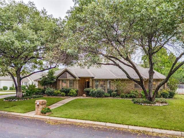 single story home with brick siding and a front lawn