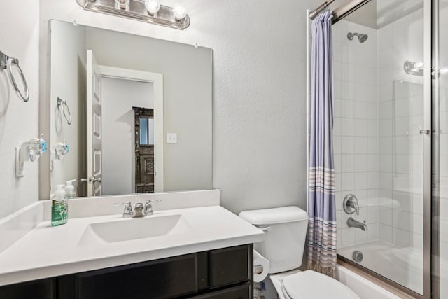 full bath featuring a textured wall, vanity, shower / bath combination with curtain, and toilet