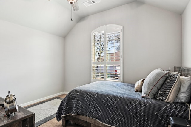 bedroom featuring visible vents, vaulted ceiling, baseboards, and ceiling fan