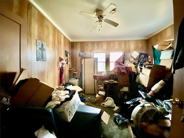 miscellaneous room with ceiling fan and wooden walls