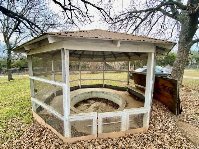 exterior space featuring fence, a carport, and a gazebo