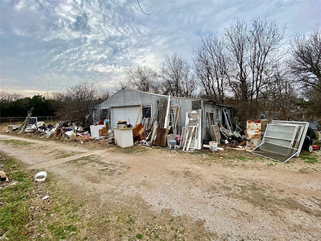 view of outdoor structure featuring an outbuilding and dirt driveway