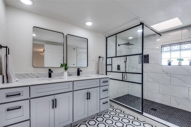 bathroom featuring a skylight, a walk in shower, double vanity, and recessed lighting