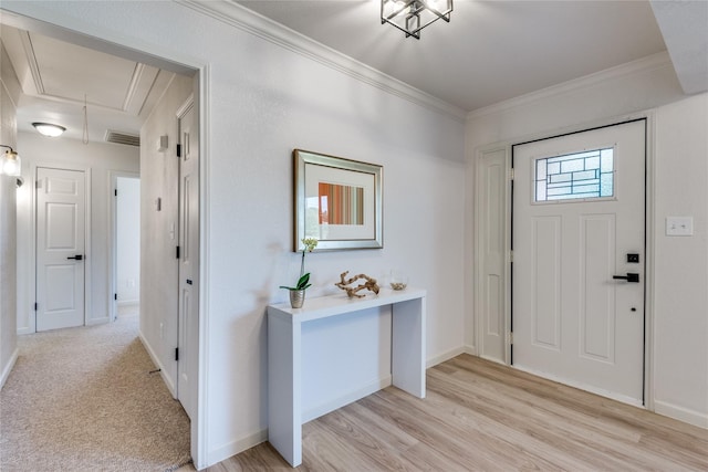 entrance foyer with light wood-style floors, visible vents, crown molding, and baseboards