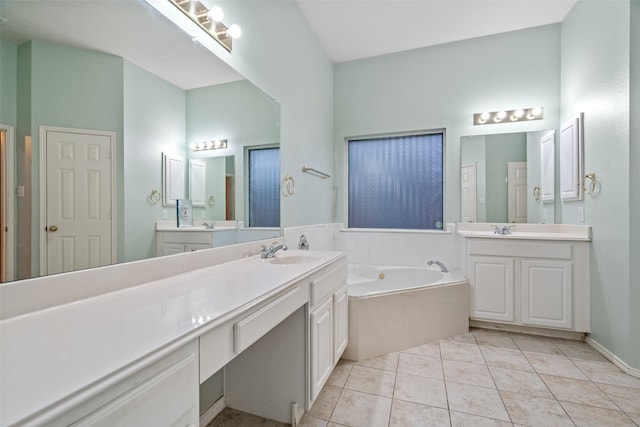 full bathroom featuring a garden tub, tile patterned flooring, two vanities, and a sink