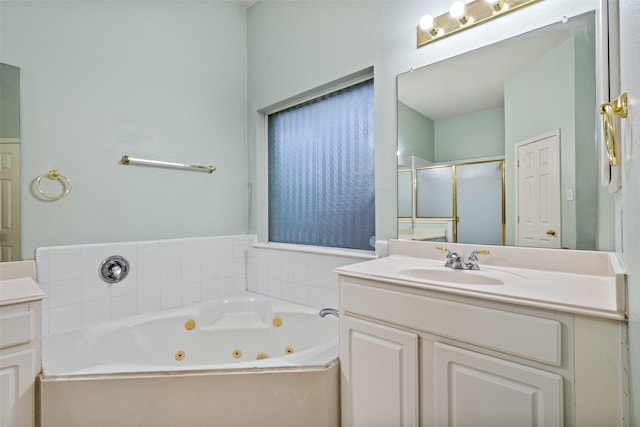 full bath featuring a whirlpool tub, a shower stall, and vanity