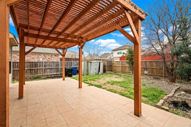 view of patio / terrace featuring a fenced backyard, a storage unit, a pergola, and an outdoor structure