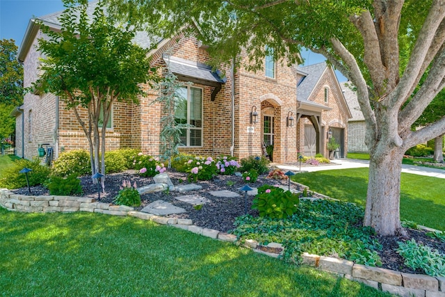 4301 Whitley Place Dr, Prosper, TX 75078 - view of front facade with brick siding, a front lawn, and a shingled roof