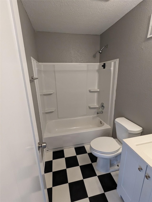 bathroom with toilet, vanity, tile patterned floors, a textured ceiling, and shower / bathtub combination