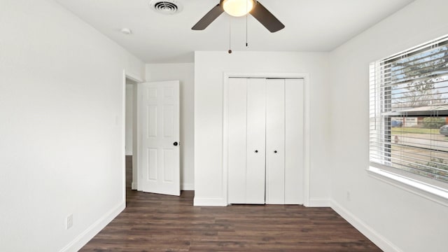 unfurnished bedroom with visible vents, baseboards, and wood finished floors