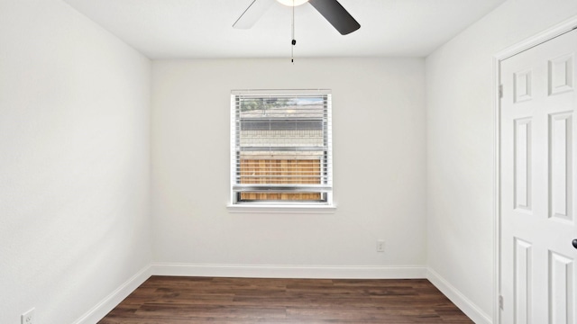 empty room with ceiling fan, dark wood-type flooring, and baseboards