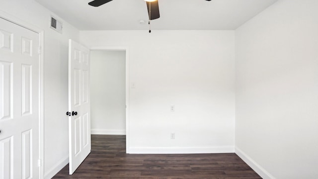 unfurnished room featuring ceiling fan, dark wood-type flooring, visible vents, and baseboards