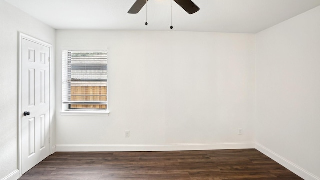 unfurnished room with dark wood-style flooring, a ceiling fan, and baseboards