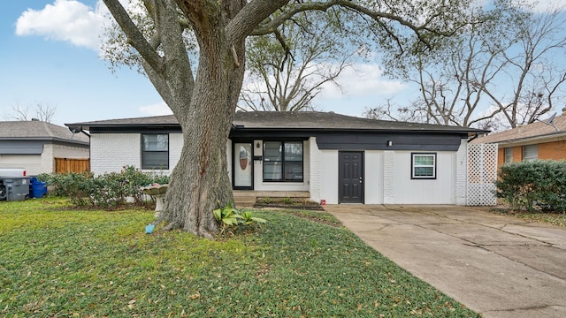 ranch-style house with brick siding and a front lawn