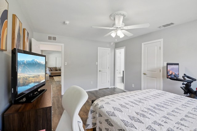 bedroom with baseboards, connected bathroom, visible vents, and dark wood-type flooring