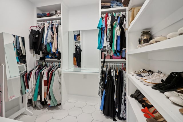 spacious closet with tile patterned floors