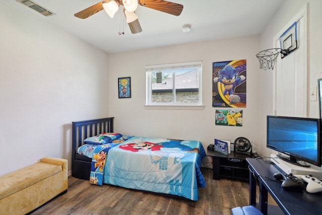 bedroom with a ceiling fan, visible vents, and wood finished floors