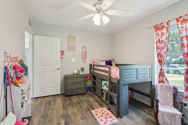 bedroom featuring ceiling fan, visible vents, and wood finished floors