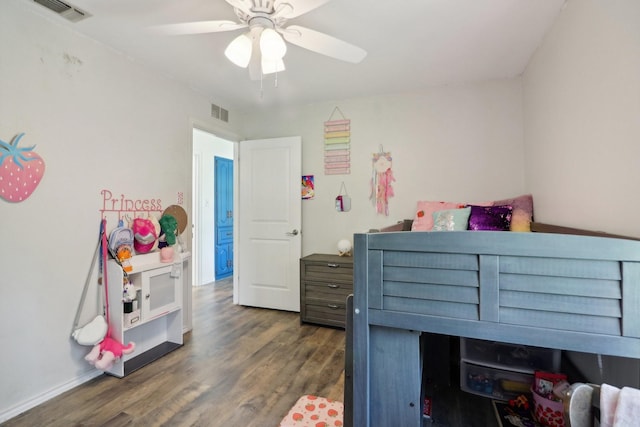 bedroom with a ceiling fan, visible vents, and wood finished floors