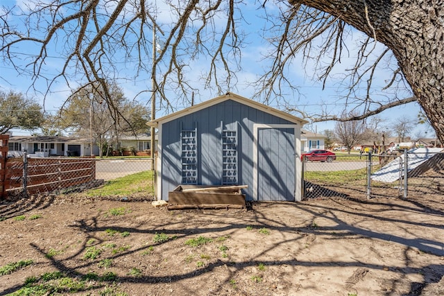 view of outbuilding featuring a gate, an outbuilding, and fence