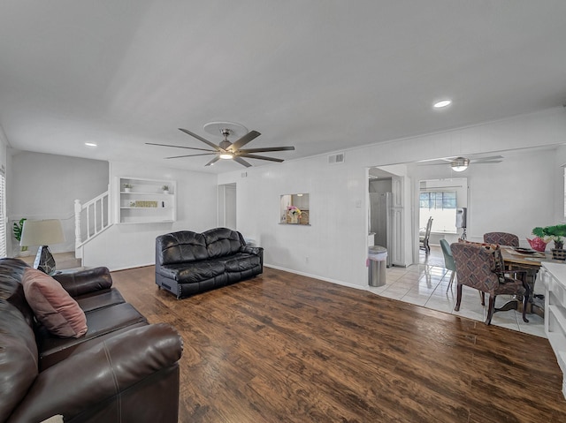 living room with recessed lighting, wood finished floors, visible vents, a ceiling fan, and stairway