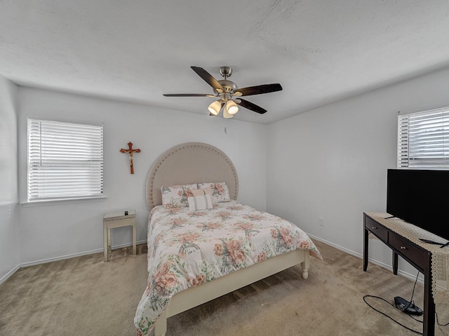 bedroom with ceiling fan, carpet flooring, and baseboards