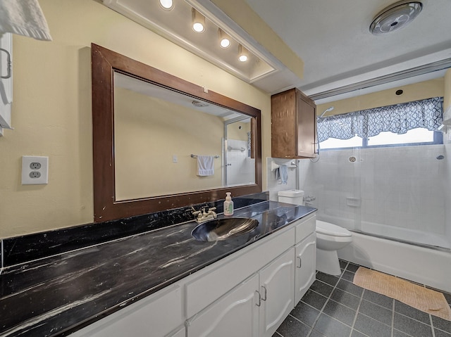 bathroom featuring shower / bath combination with glass door, vanity, toilet, and tile patterned floors