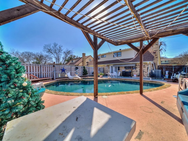 view of swimming pool featuring a patio, fence, and a fenced in pool