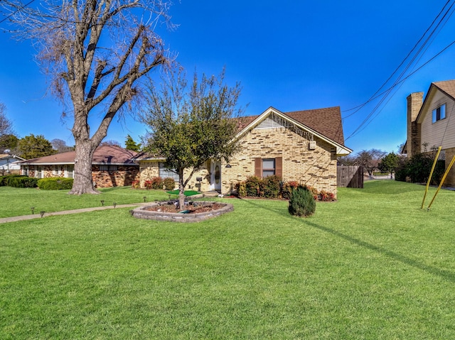 view of front of house featuring brick siding and a front lawn