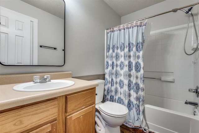 full bathroom featuring shower / bath combo, a textured ceiling, toilet, and vanity