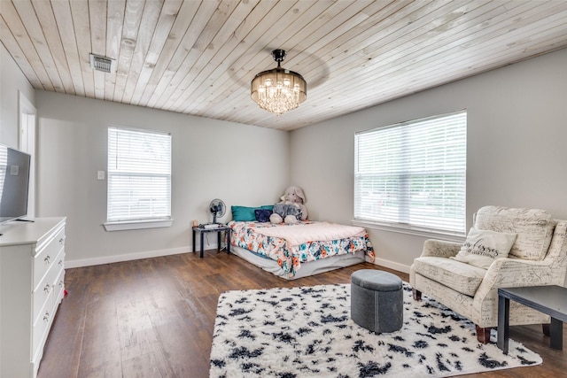 bedroom featuring an inviting chandelier, multiple windows, visible vents, and dark wood-style flooring