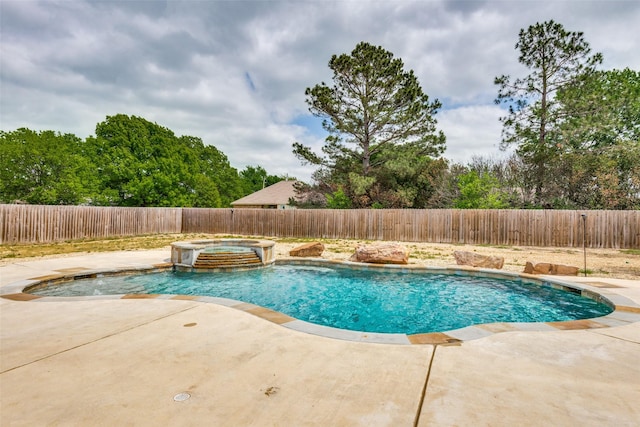 view of pool featuring a patio area, a fenced backyard, and a pool with connected hot tub