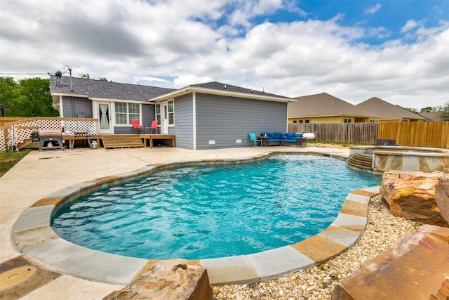 view of pool featuring a fenced in pool, a patio area, fence, a deck, and an in ground hot tub