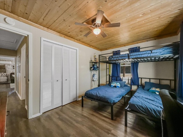 bedroom with wooden ceiling, attic access, a closet, and wood finished floors