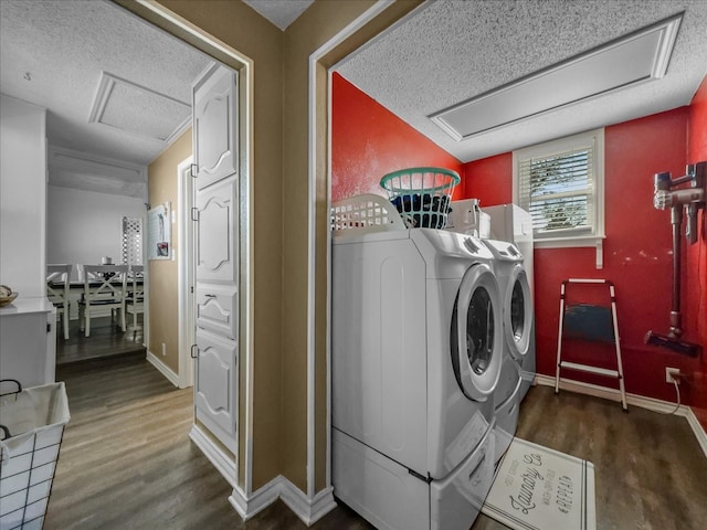 laundry room featuring laundry area, separate washer and dryer, wood finished floors, baseboards, and attic access