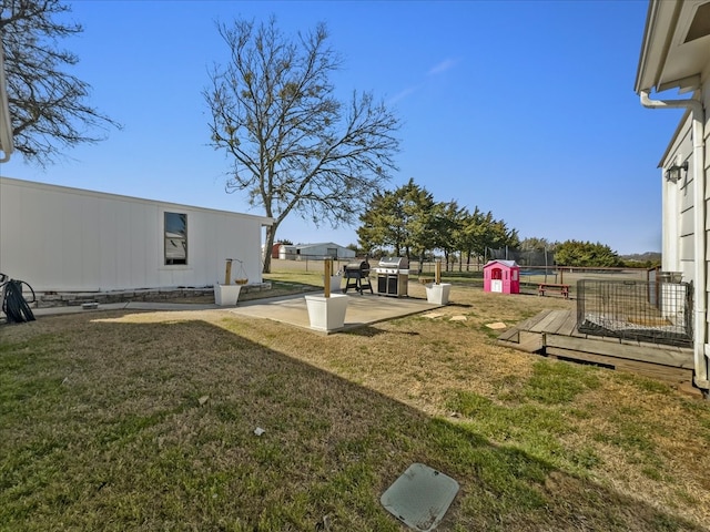 view of yard with a patio, a deck, and fence