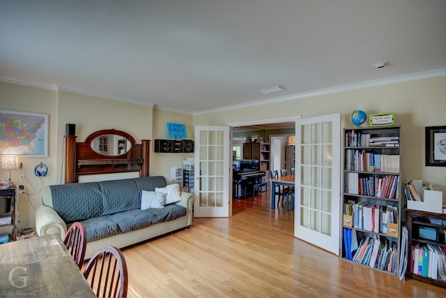 living area with french doors, wood finished floors, and crown molding